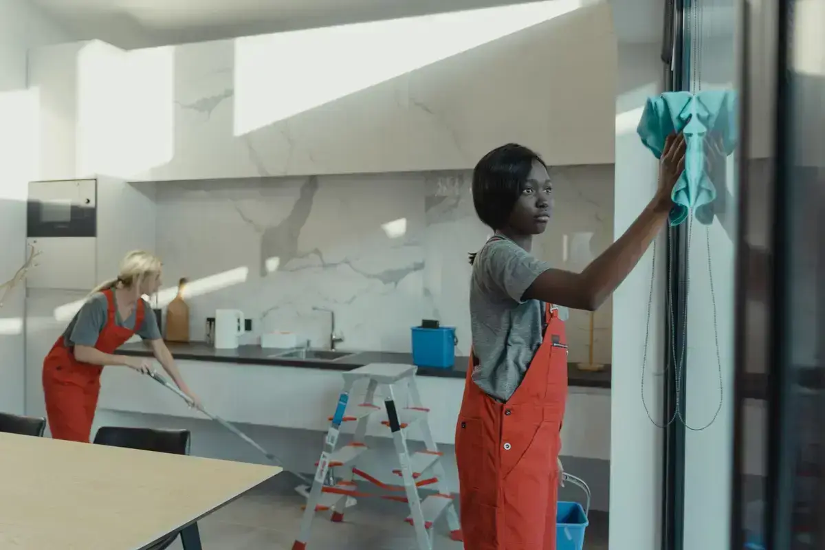Deep-cleaning crew working through a kitchen after a tenancy
